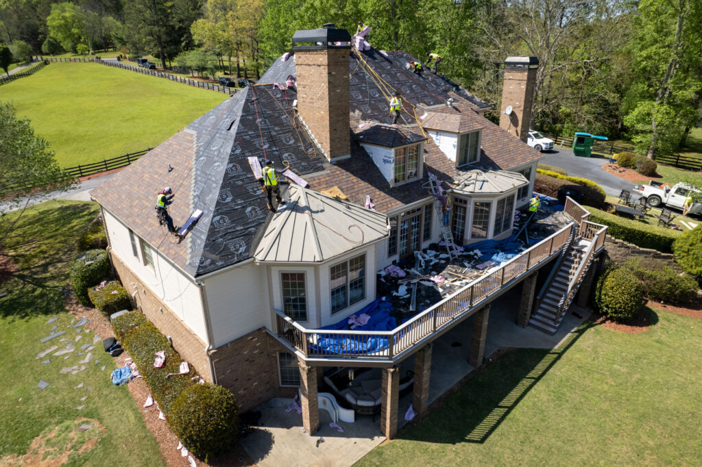 Expert asphalt shingle roofing team working on a residential roof in Twin Cities, MN