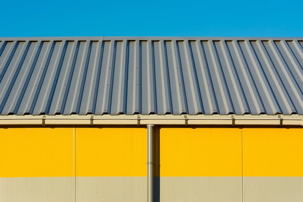 Roofing expert installing panels on a metal roof